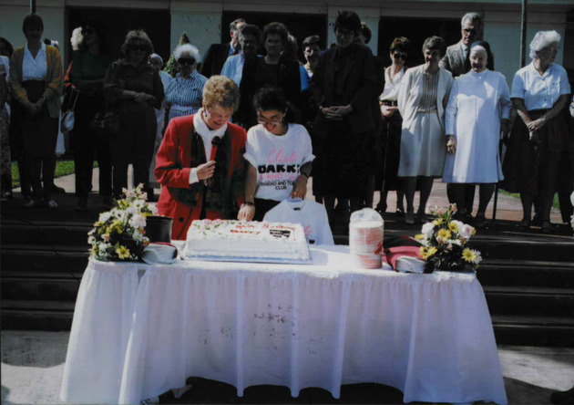 Sister Jeanne O'Laughlin, OP, and a student at the traditional cake cutting ceremony for the university's anniversary